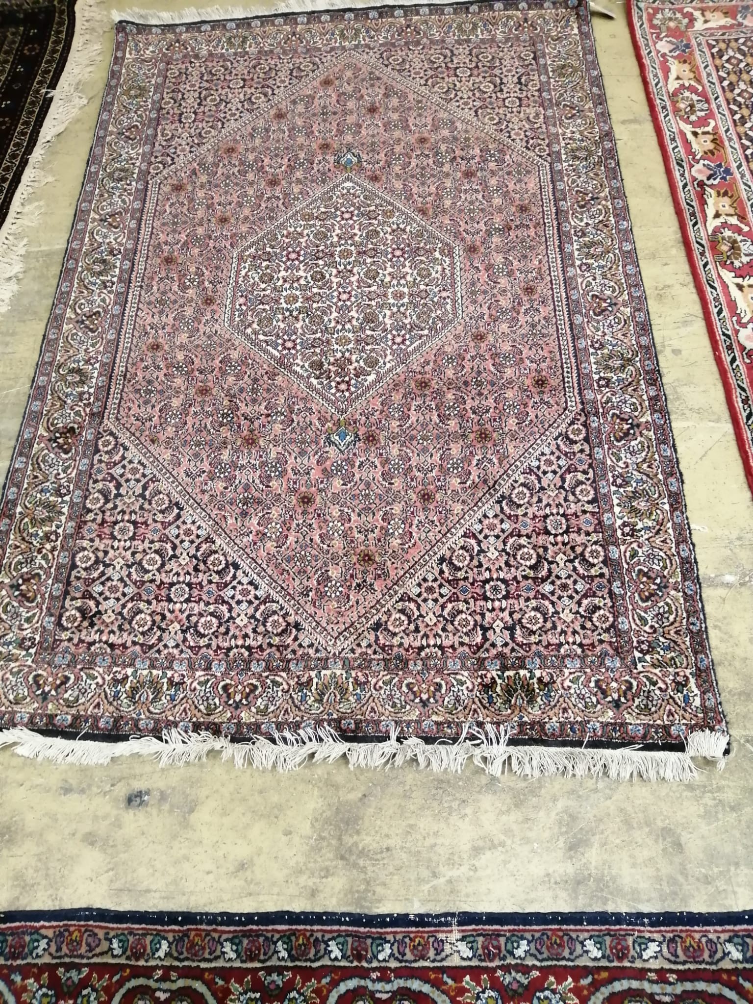 A North West Persian ivory ground rug, 170 x 112cm